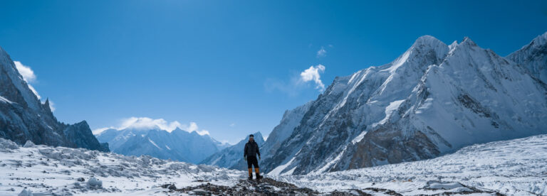 Wide shot of Sajid Sadpara outside K2 basecamp in winter
