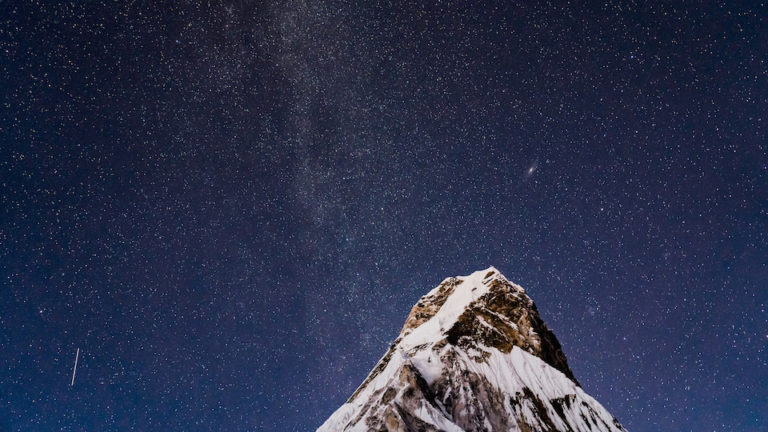 Stars and the Milky Way hovering high above Ama Dablam